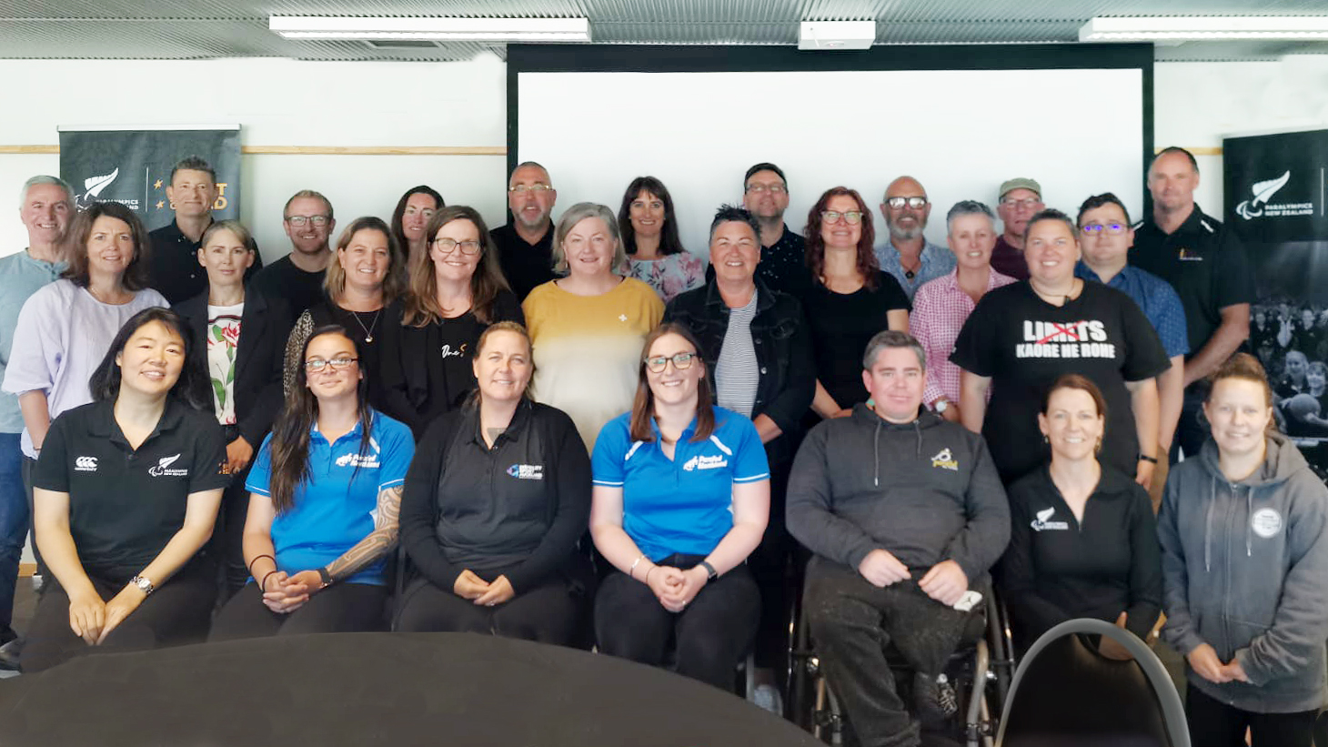 Large group of workshop participants sitting for photo