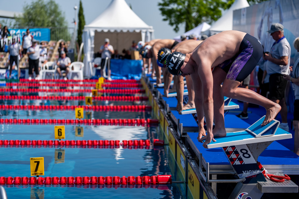 Jack Bugler poised on starting blocks of outdoor pool