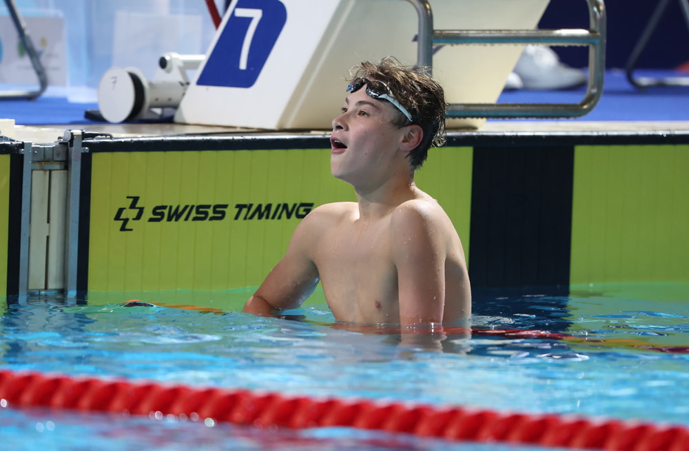 Joshua comes out of the water with a hopeful look on his face at the end of a race