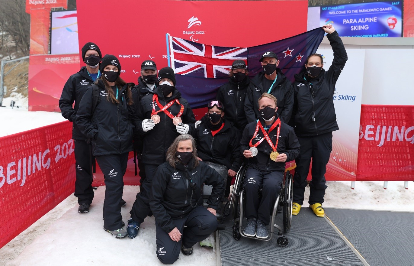 The New Zealand Team at the Beijing 2022 Paralympic Winter Games left to right: Physio Graeme White, Deputy Chef de Mission Gracey, Wax tech Curtis Christian, Paralympian Adam Hall, Chef de Mission Jane Stevens, Paralympian Aaron Ewen, Assistant Coach Scott Palmer, Paralympian Corey Peters, Medical Lead Dr Bruce Hamilton, Head Coach Ben Adams.