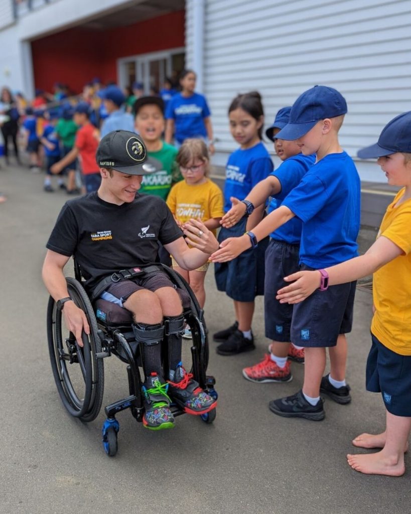 Para Sport Champion Jaden Movold with tamariki at Ellerslie School